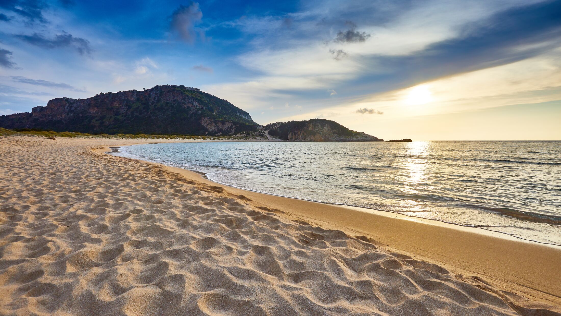 Amazing sunset view with multicolored clouds. Incredibly romantic sunrise on Voidokilia beach, Ionian Sea, Pilos town location, Greece, Europe. View of the ocean. Tropical beach