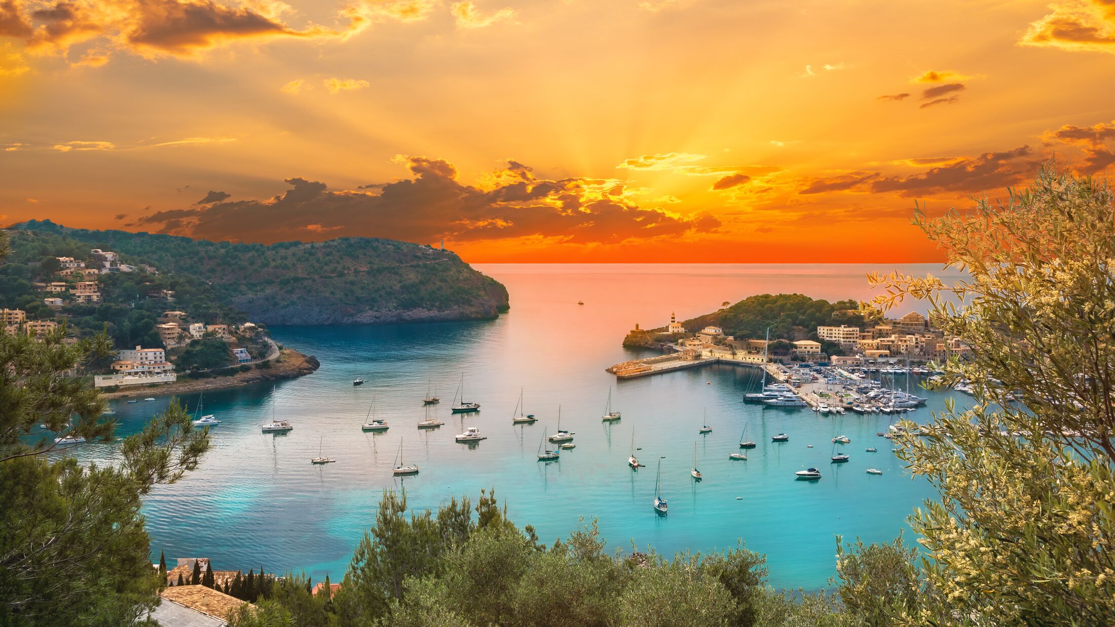 View of the famous Soller Port Marina and Dockland illuminated by sunset light in Palma de Majorca in Spain in summer season
